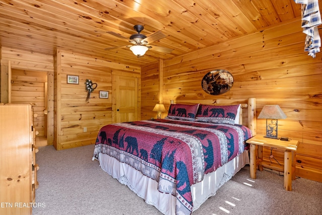 bedroom featuring carpet, wooden ceiling, and wooden walls