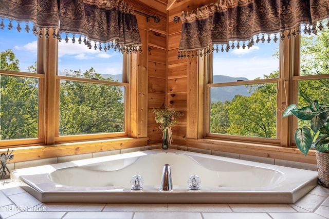 bathroom with a wealth of natural light, a garden tub, and wood walls