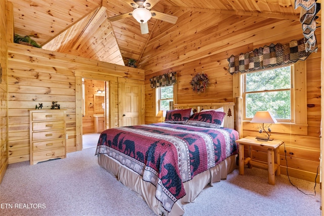 bedroom featuring wood walls, wood ceiling, lofted ceiling, carpet floors, and ensuite bath