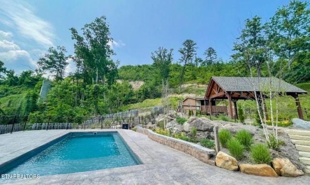 view of swimming pool featuring a fenced in pool and fence