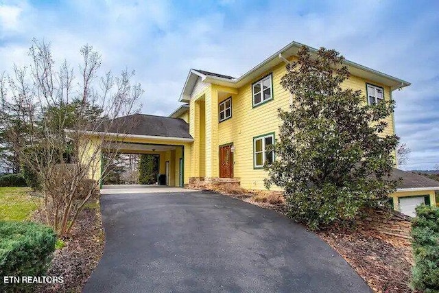 view of side of home featuring a carport and driveway