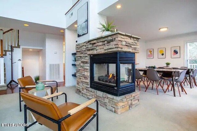 living area with visible vents and a fireplace