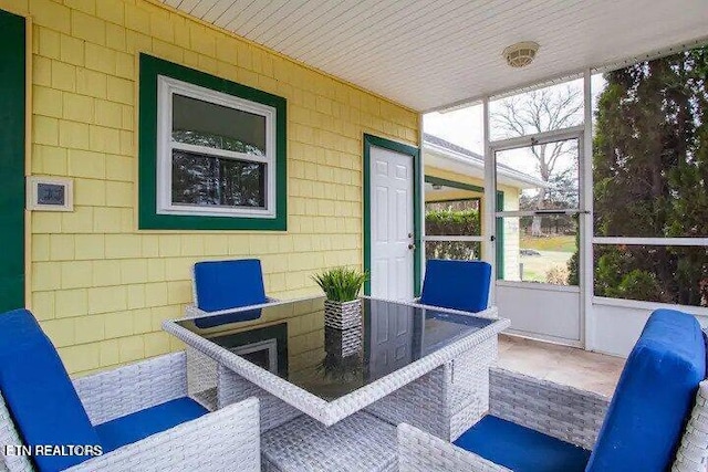 sunroom / solarium featuring plenty of natural light and wood ceiling