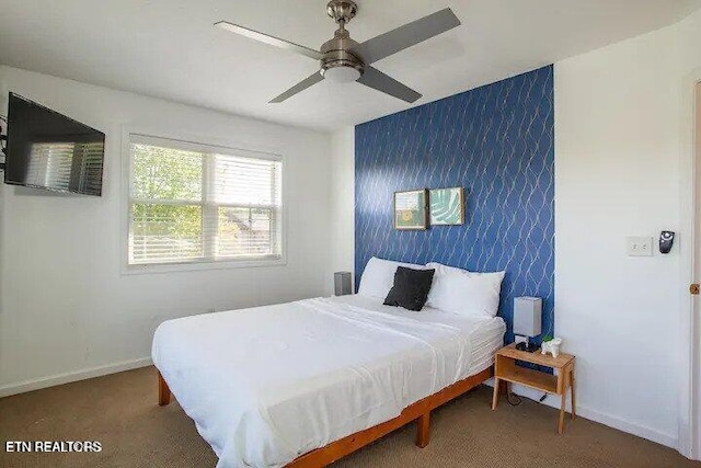 bedroom featuring ceiling fan and baseboards