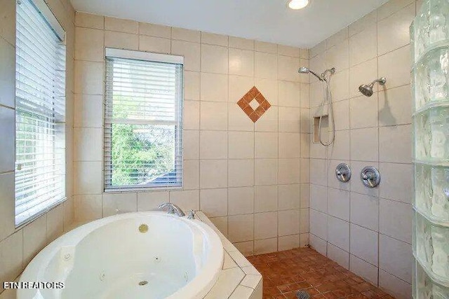 full bathroom featuring tiled shower, tile walls, and a whirlpool tub