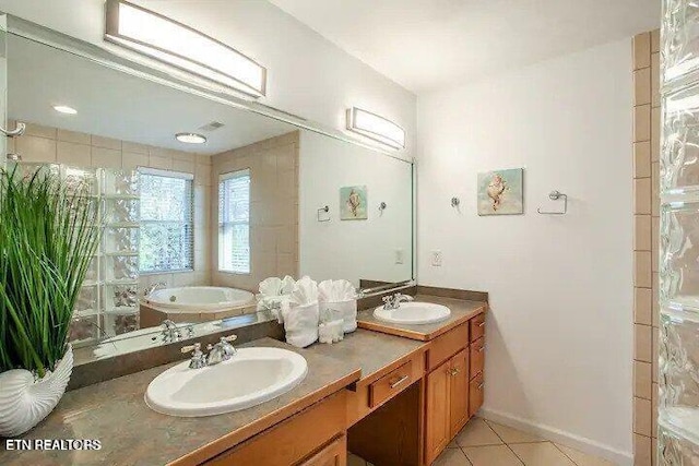 full bathroom with a sink, double vanity, tile patterned floors, and a washtub