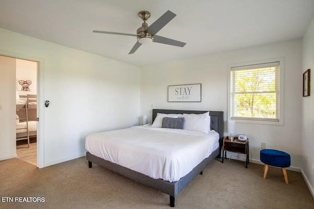 bedroom featuring a ceiling fan, light colored carpet, and baseboards