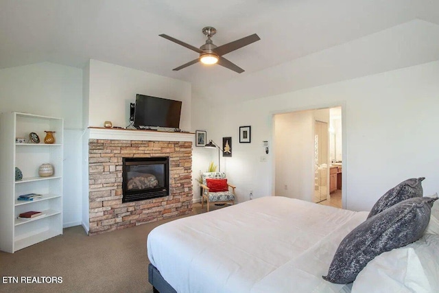 bedroom featuring carpet floors, lofted ceiling, and a fireplace