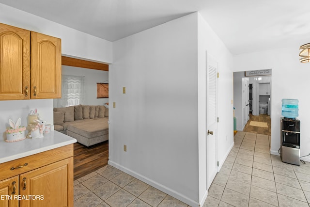 kitchen featuring light tile patterned floors, baseboards, and light countertops