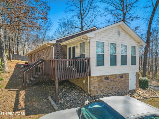 view of home's exterior featuring a wooden deck