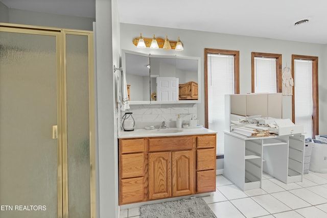 full bathroom with tile patterned flooring, visible vents, backsplash, a stall shower, and vanity