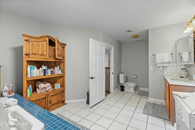 full bath featuring backsplash, baseboards, toilet, tile patterned floors, and vanity