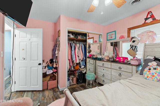 bedroom featuring a closet, visible vents, a ceiling fan, and wood finished floors