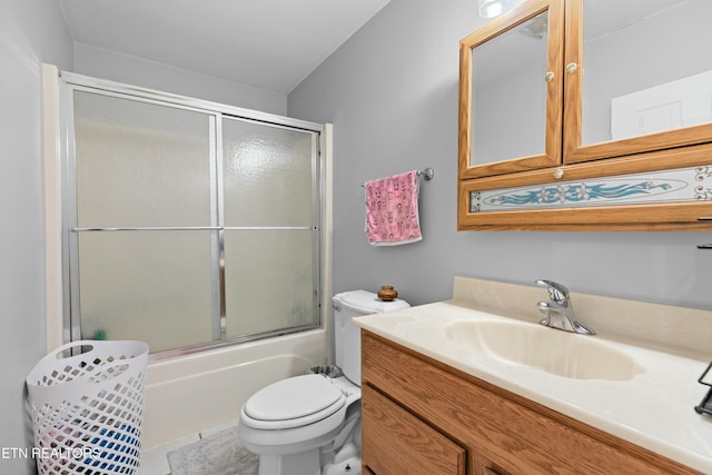 full bath featuring toilet, vanity, and bath / shower combo with glass door