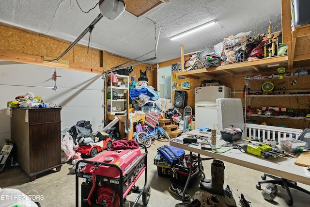 garage with freestanding refrigerator and a garage door opener