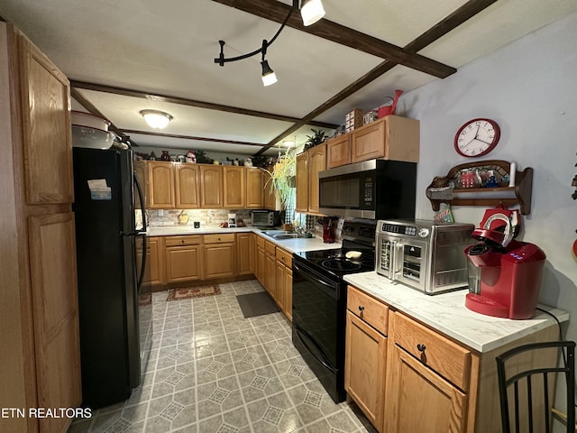 kitchen featuring beamed ceiling, black appliances, tasteful backsplash, a toaster, and light countertops