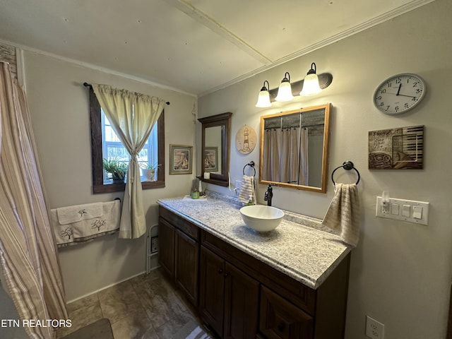 bathroom with vanity and ornamental molding