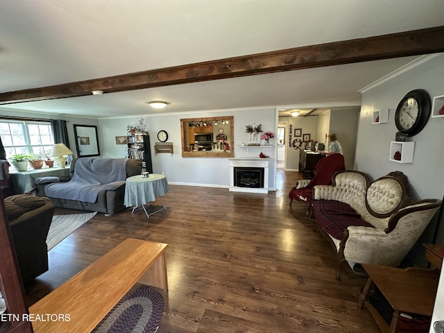 living room featuring beamed ceiling, ornamental molding, wood finished floors, a fireplace, and baseboards