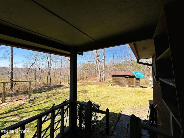 view of yard with a storage shed and an outdoor structure