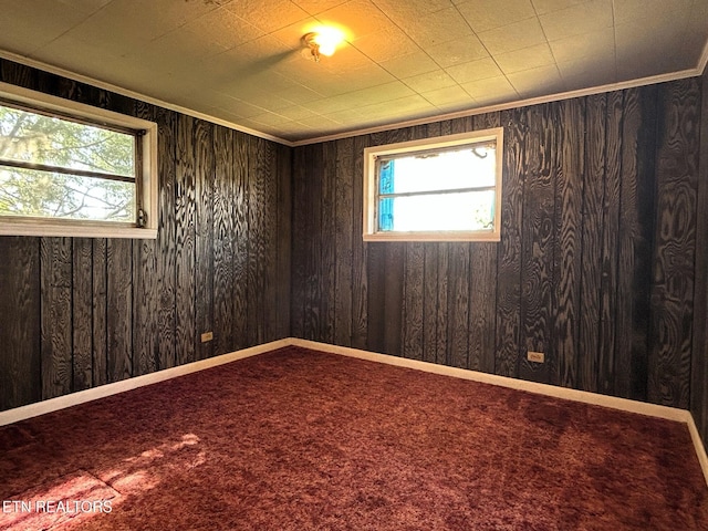 carpeted empty room with baseboards and ornamental molding