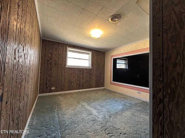 carpeted spare room featuring visible vents and baseboards