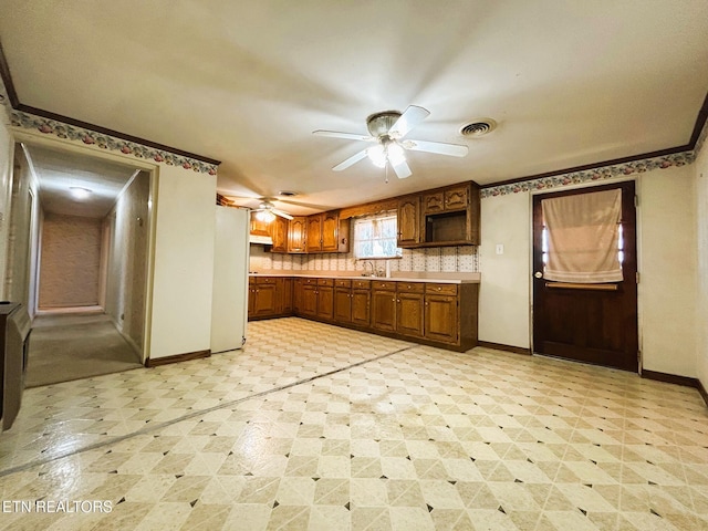 kitchen with visible vents, baseboards, light floors, freestanding refrigerator, and a ceiling fan