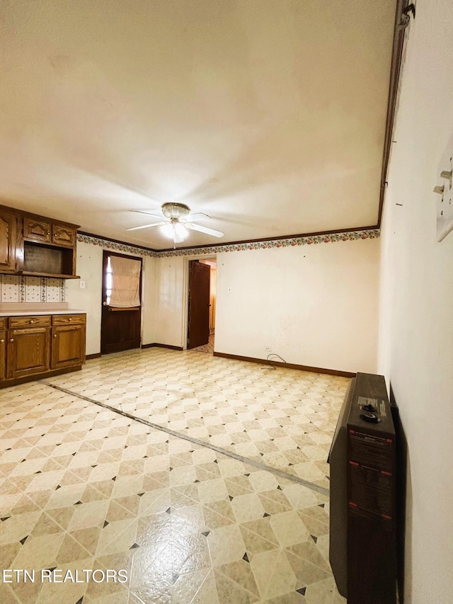 unfurnished living room with baseboards and light floors