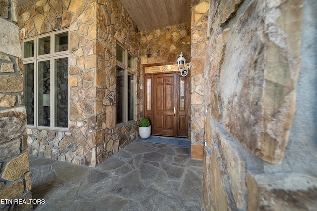 doorway to property with stone siding