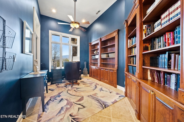 office featuring light tile patterned floors, visible vents, baseboards, and a ceiling fan