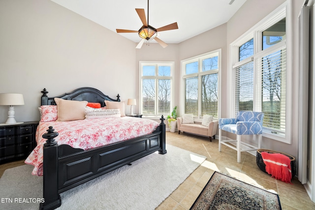 bedroom with ceiling fan and light tile patterned flooring