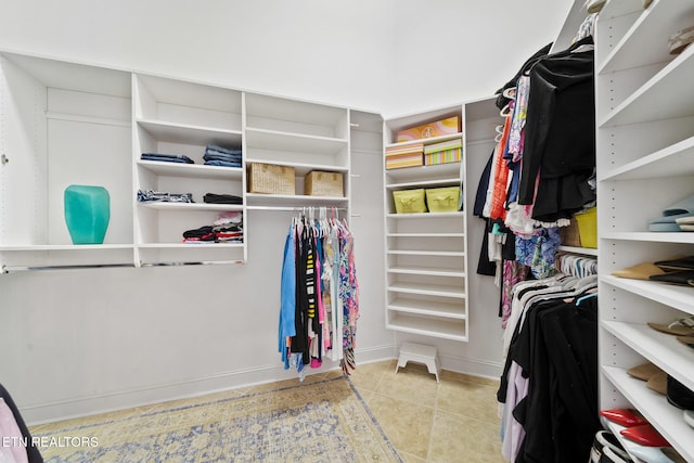 spacious closet with tile patterned floors