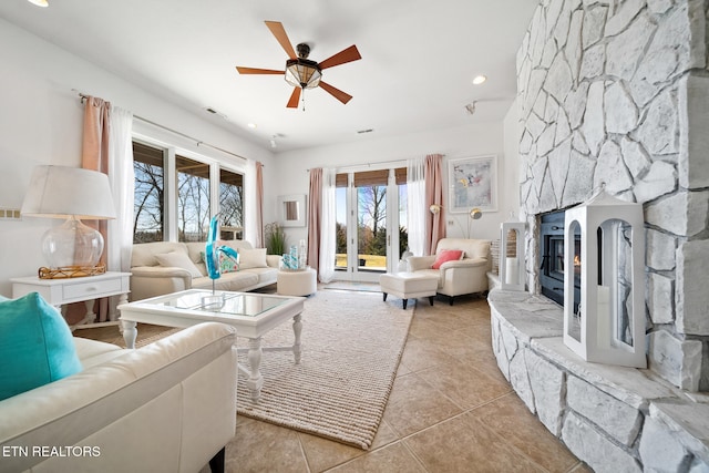 living area featuring recessed lighting, a ceiling fan, light tile patterned flooring, and a fireplace