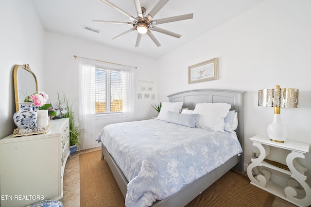 bedroom featuring light tile patterned flooring, visible vents, and a ceiling fan