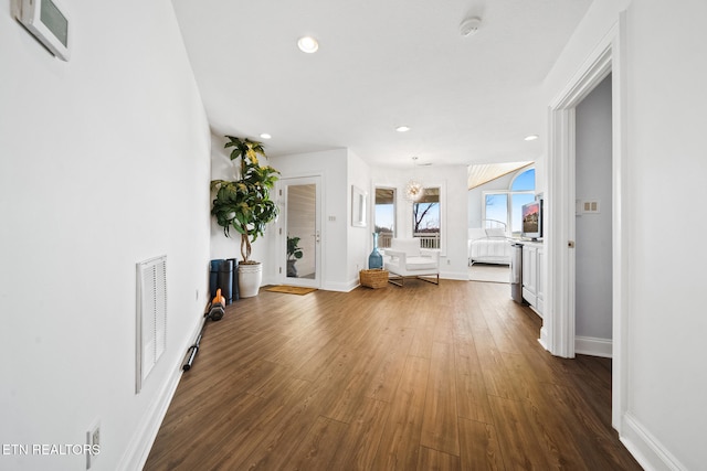 interior space with recessed lighting, visible vents, dark wood-style flooring, and baseboards