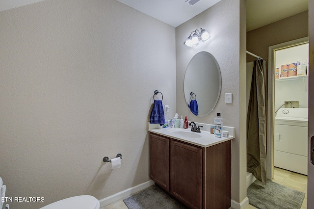 bathroom featuring vanity, a shower with curtain, baseboards, washer / clothes dryer, and toilet