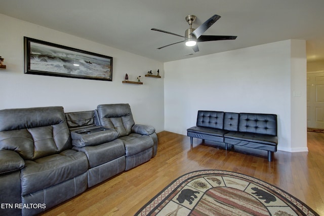 living room featuring visible vents, ceiling fan, and wood finished floors