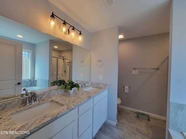 bathroom featuring visible vents, a stall shower, a garden tub, and a sink