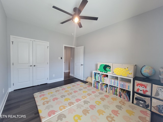 playroom featuring ceiling fan, baseboards, and wood finished floors