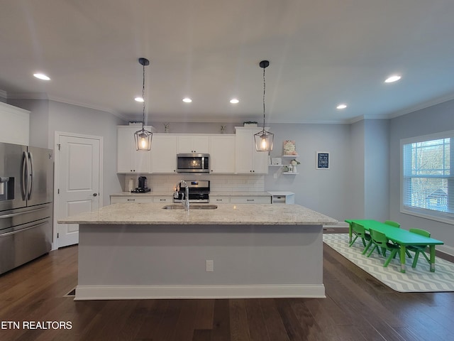 kitchen with backsplash, crown molding, dark wood finished floors, stainless steel appliances, and a sink