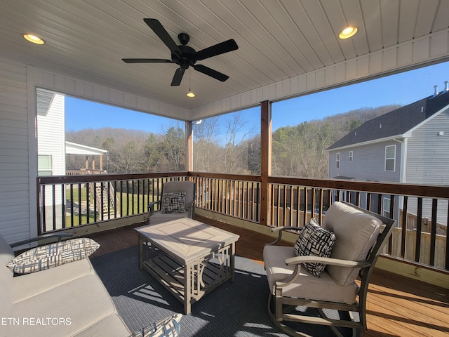 wooden deck featuring a ceiling fan