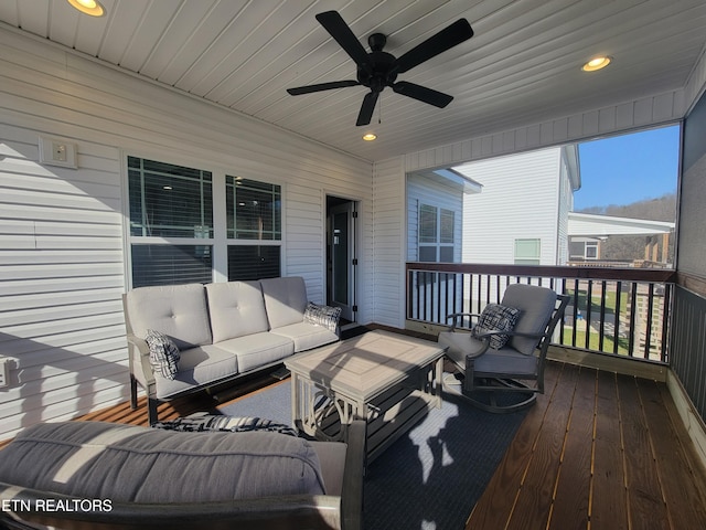 deck with outdoor lounge area and a ceiling fan