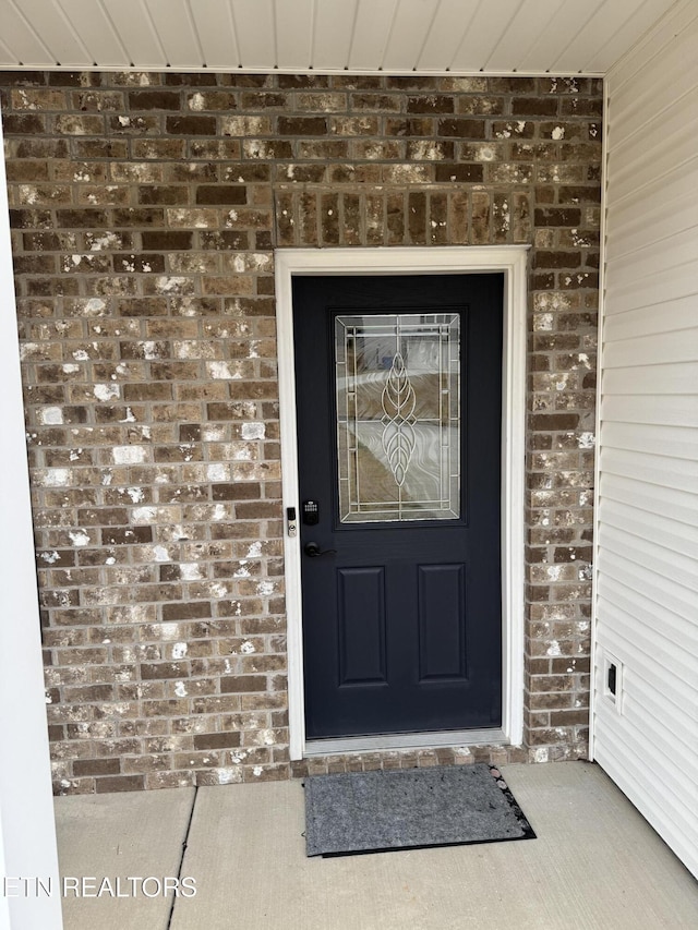 entrance to property with brick siding