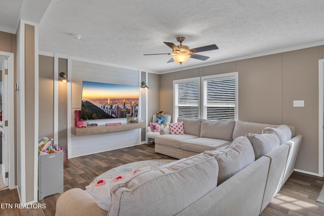 living area with a textured ceiling, ceiling fan, and wood finished floors