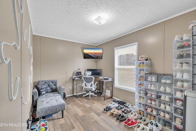 office area featuring a textured ceiling, crown molding, and wood finished floors