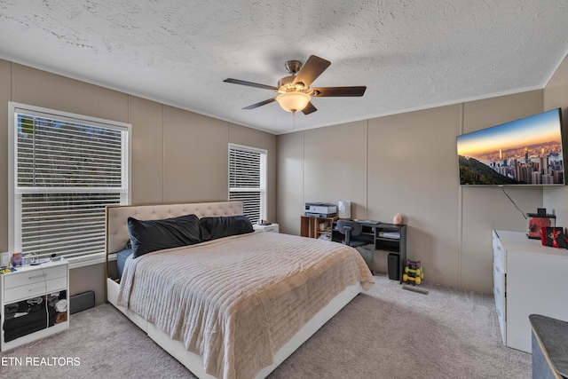 bedroom featuring a decorative wall, carpet flooring, and a textured ceiling