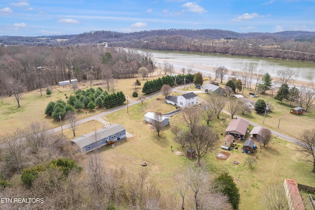 bird's eye view with a forest view and a water view