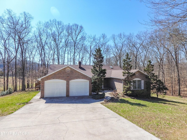 view of front of property featuring a front lawn, concrete driveway, brick siding, and an attached garage