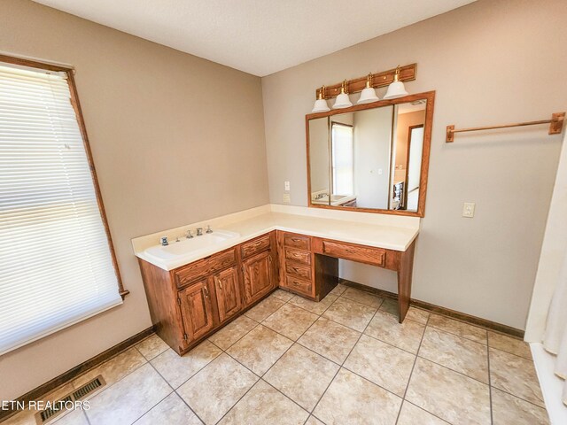 bathroom featuring visible vents, plenty of natural light, and vanity