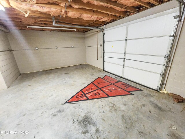 garage with concrete block wall