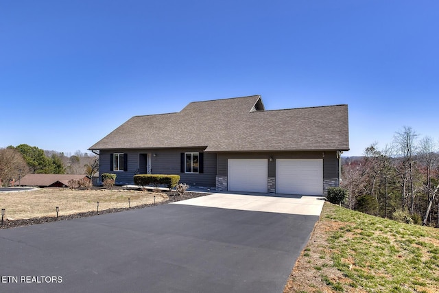 view of front facade featuring concrete driveway, an attached garage, stone siding, and a shingled roof